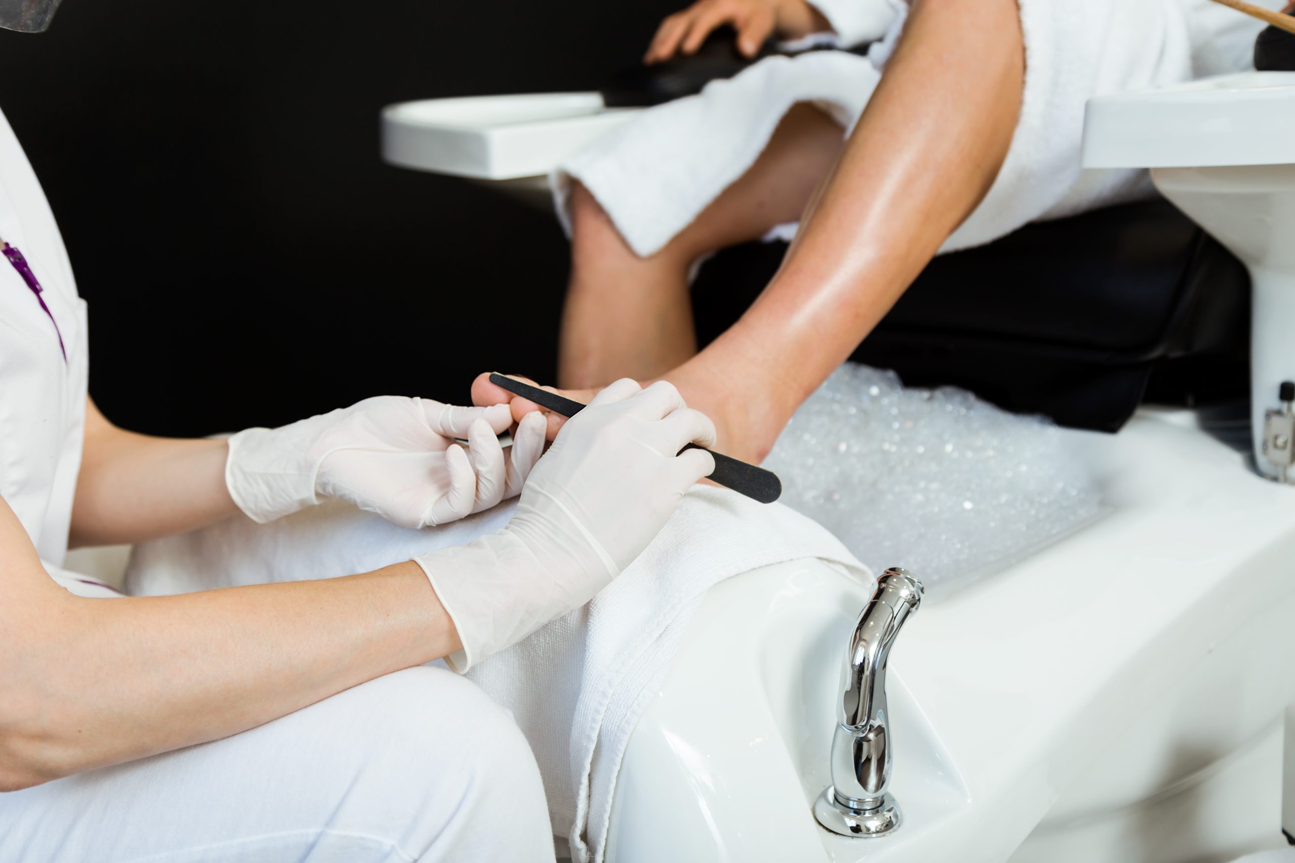 Young Man Doing Pedicure Salon Beauty Concept